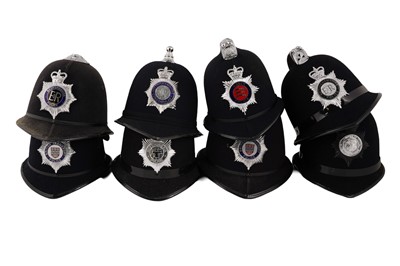 Lot 151 - A collection of eight police helmets