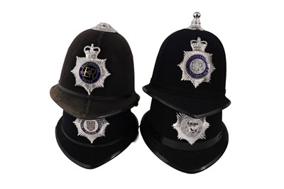 Lot 151 - A collection of eight police helmets