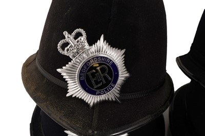Lot 151 - A collection of eight police helmets
