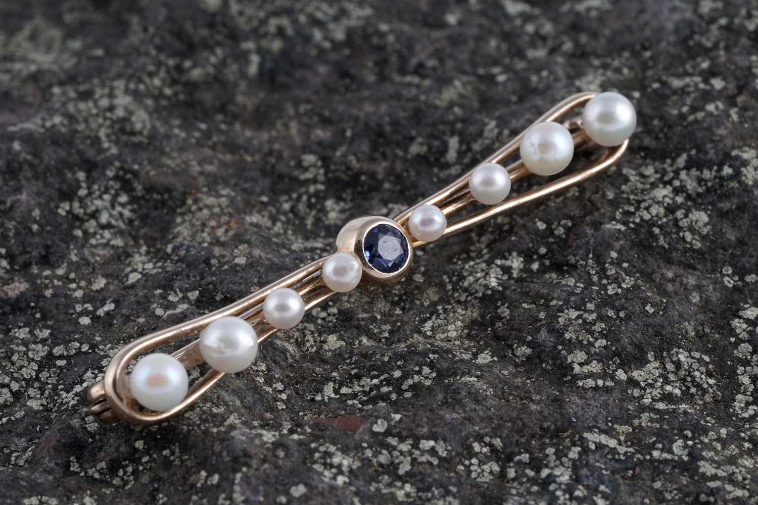Lot 7 - A 1930's bow-pattern sapphire and pearl bar brooch