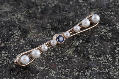 Lot 7 - A 1930's bow-pattern sapphire and pearl bar brooch