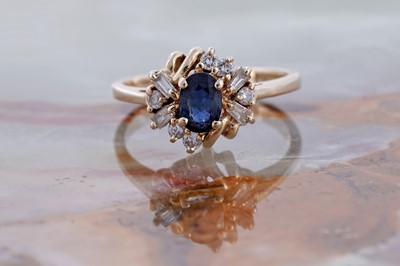 Lot 75 - A modern sapphire and diamond ring