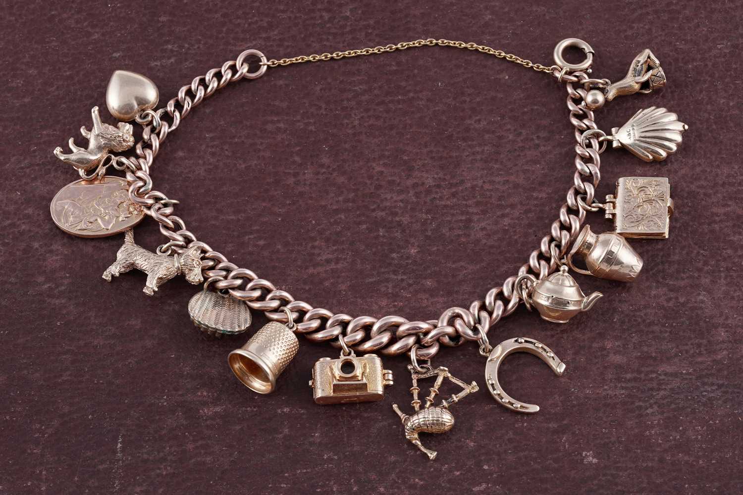 Lot 38 - A 9ct rose gold charm bracelet