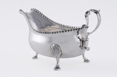Lot 60 - A George III silver sauceboat on three legs