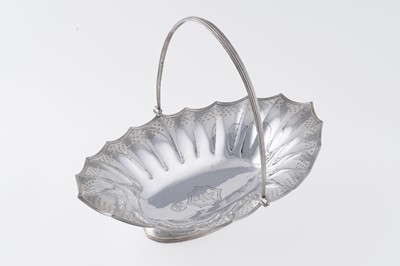 Lot 62 - A George III silver swing-handled cake basket