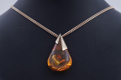 Lot 264 - An amber pendant on chain