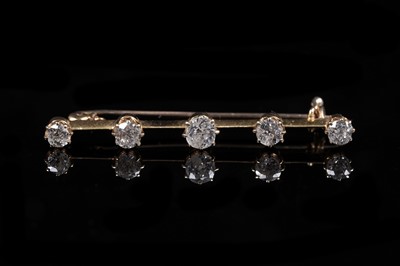 Lot 899 - A five stone diamond bar brooch