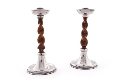 Lot 47 - A pair of George V arts and crafts silver mounted candlesticks