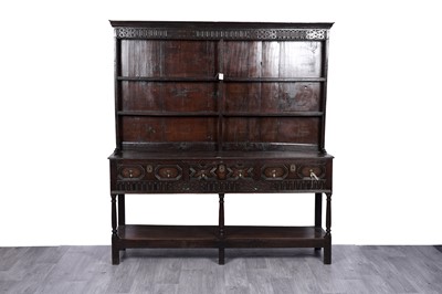 Lot 79 - A George III and later carved oak dresser