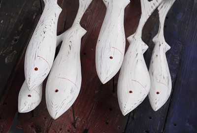 Lot 651 - Max Tannahill - Fishes | sculpture: a wooden shoal of fish and the remnants of a boat hull