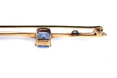Lot 41 - A "Swiss blue" topaz bar brooch, and a gold leaf-pattern brooch