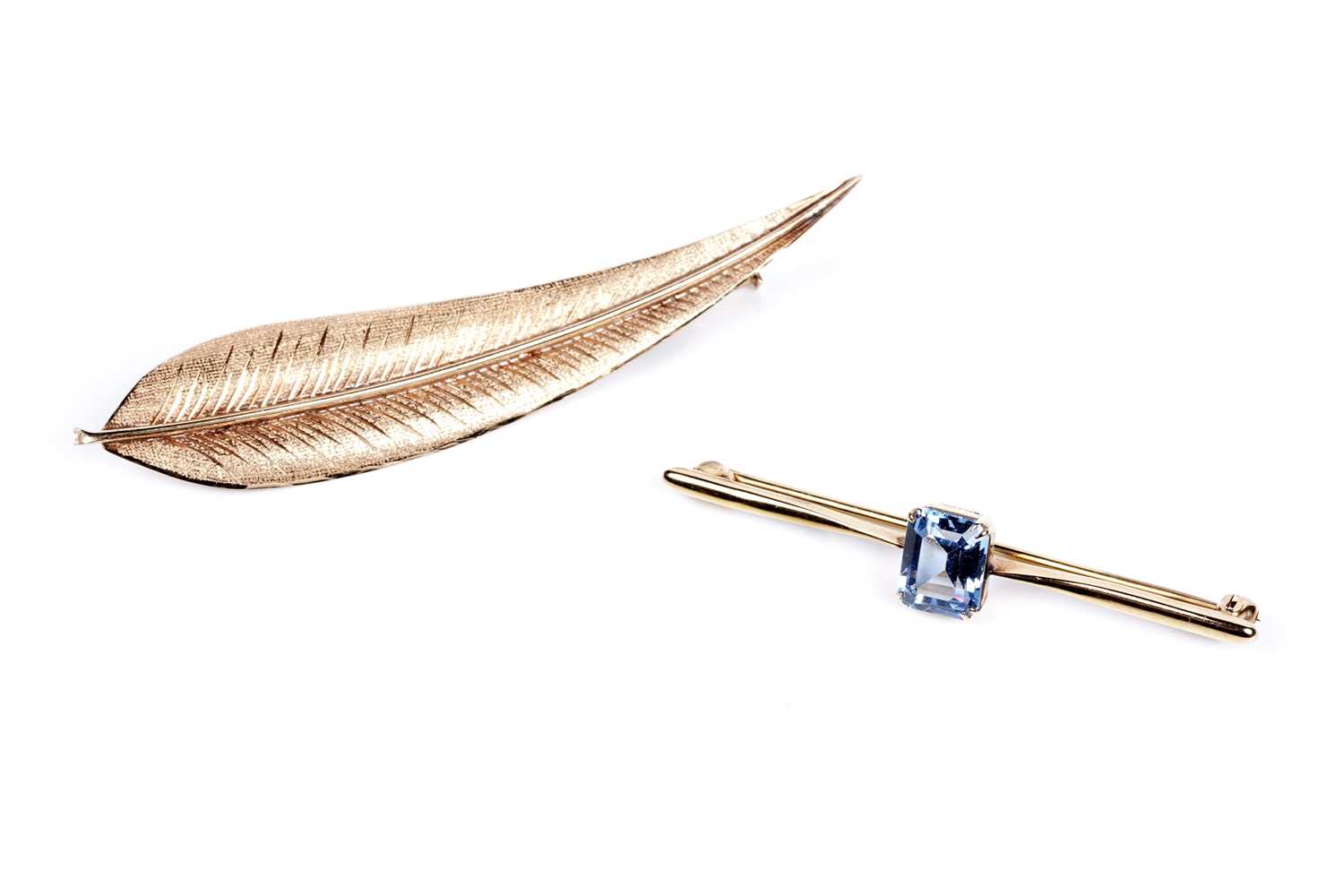 Lot 41 - A "Swiss blue" topaz bar brooch, and a gold leaf-pattern brooch