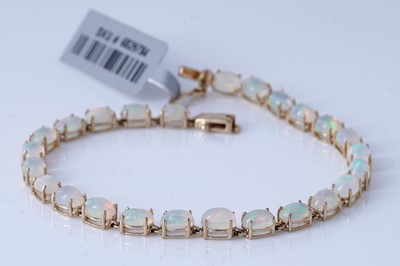 Lot 141 - A contemporary 9ct gold and opal line bracelet