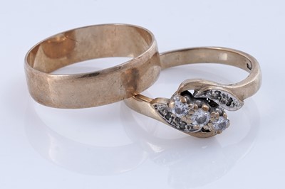 Lot 167 - A three-stone diamond ring; and a 9ct gold wedding band