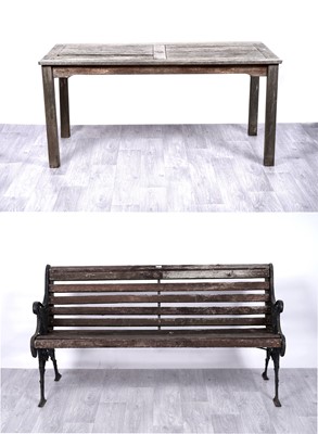 Lot 30 - A vintage cast iron and teak garden bench; and a teak garden table