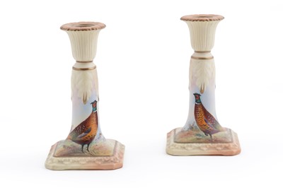 Lot 210 - A pair of Locke & Co Worcester blush ivory candlesticks