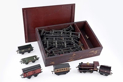 Lot 387 - A Hornby 0-gauge tin plate clockwork locomotive; and assorted rolling stock and track