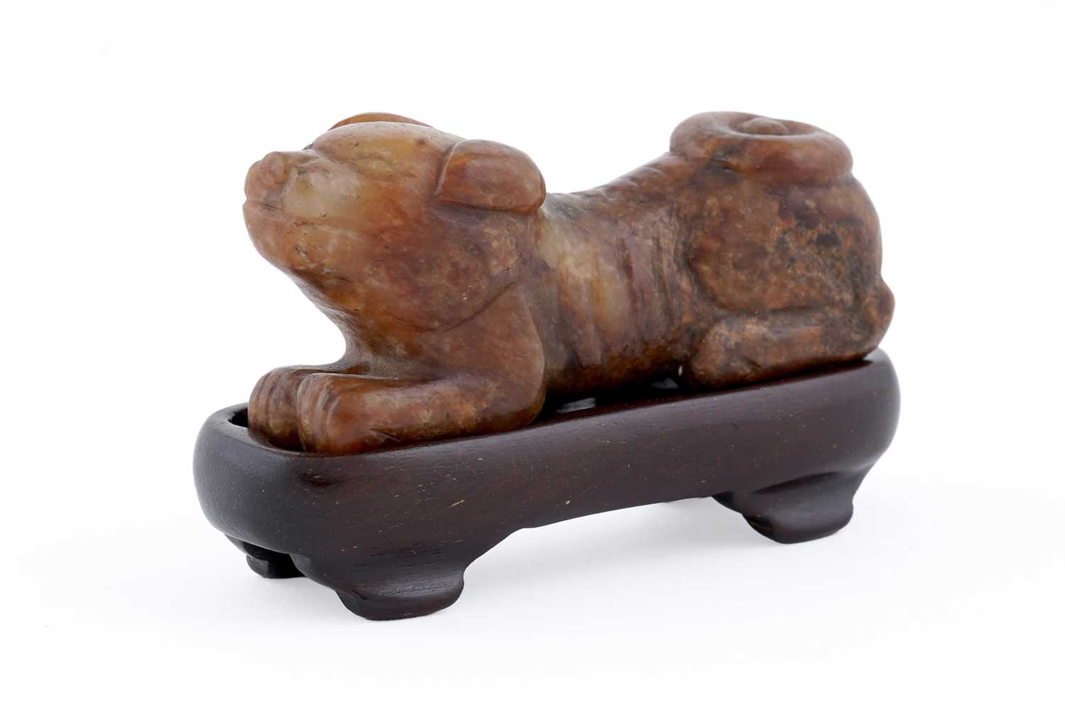 Lot 826 - A small rust coloured jade dog