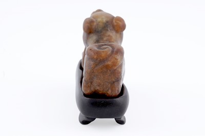 Lot 826 - A small rust coloured jade dog