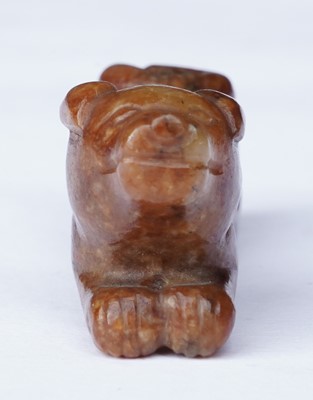 Lot 826 - A small rust coloured jade dog