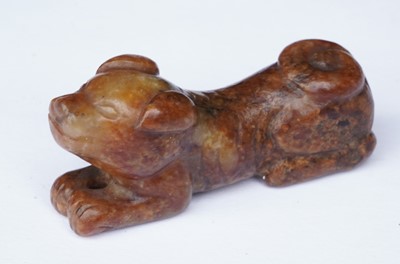 Lot 826 - A small rust coloured jade dog