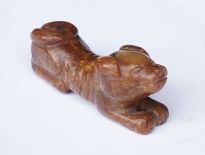 Lot 826 - A small rust coloured jade dog