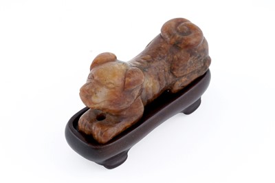 Lot 826 - A small rust coloured jade dog