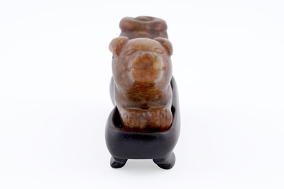Lot 826 - A small rust coloured jade dog