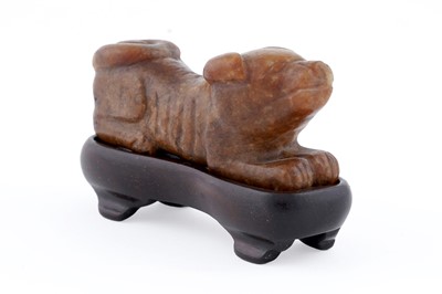 Lot 826 - A small rust coloured jade dog