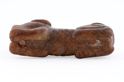 Lot 826 - A small rust coloured jade dog