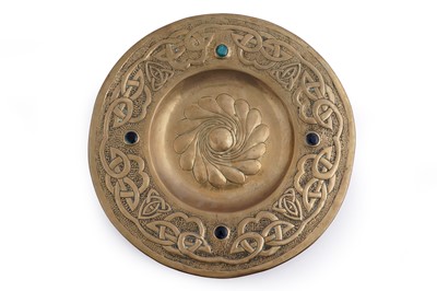 Lot 301 - In the manner of John Pearson: an Arts and Crafts hammered brass charger