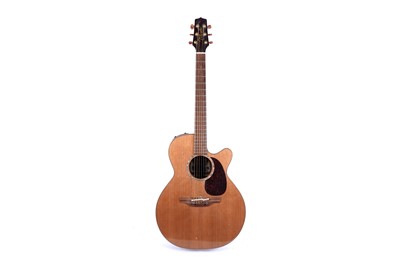 Lot 83 - A Takamine six string electro acoustic guitar