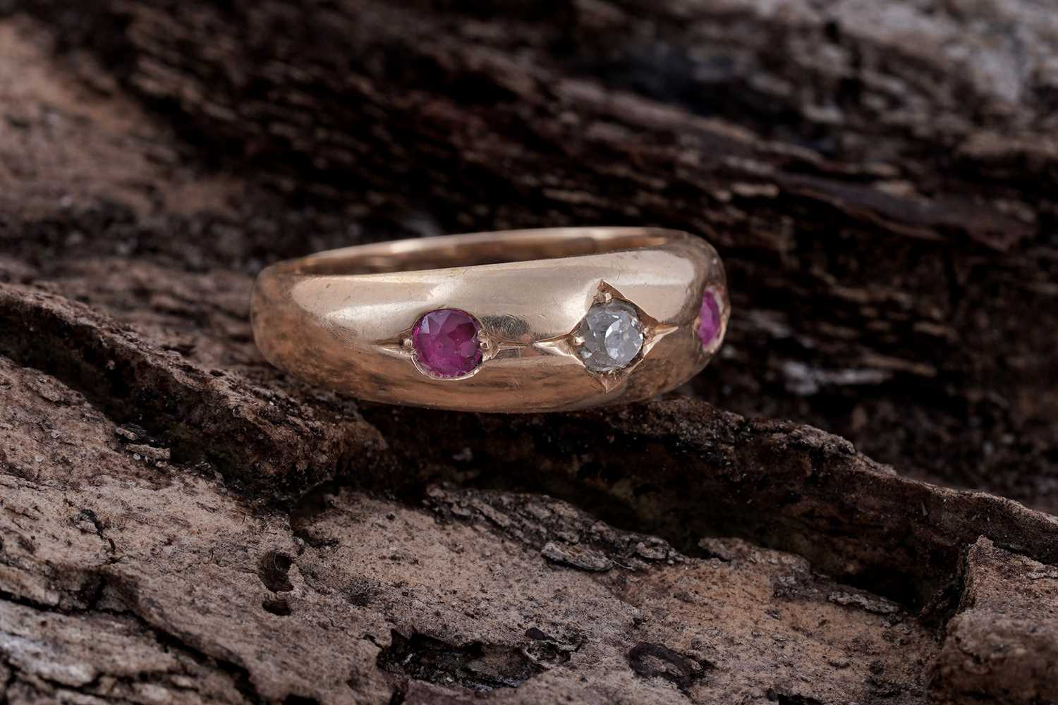 Lot 5 - A Victorian ruby and diamond gypsy-set three-stone ring on 18ct gold | dated 1893