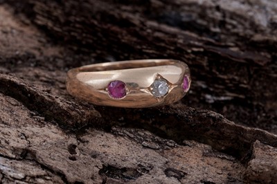 Lot 5 - A Victorian ruby and diamond gypsy-set three-stone ring on 18ct gold | dated 1893
