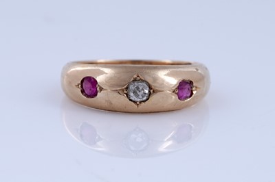Lot 5 - A Victorian ruby and diamond gypsy-set three-stone ring on 18ct gold | dated 1893