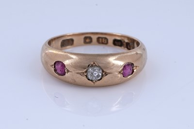 Lot 5 - A Victorian ruby and diamond gypsy-set three-stone ring on 18ct gold | dated 1893