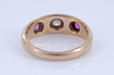 Lot 5 - A Victorian ruby and diamond gypsy-set three-stone ring on 18ct gold | dated 1893