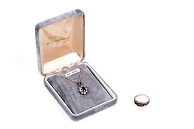 Lot 110 - A sapphire and diamond ring; and a sapphire flowerhead pattern pendant necklace