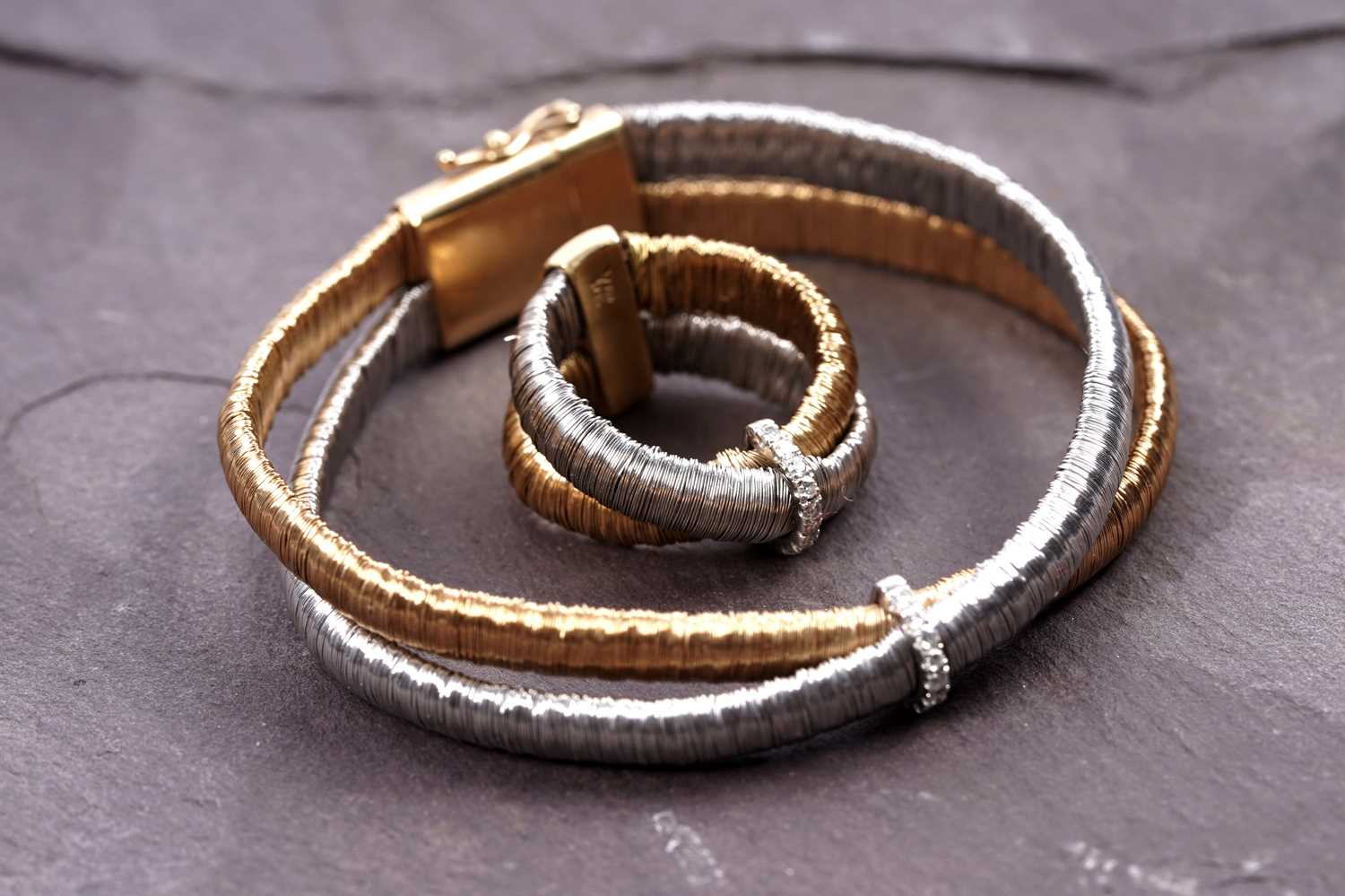 Lot 924 - Yvel: an 18ct white and yellow gold and diamond set bracelet and ring set