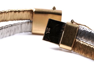 Lot 924 - Yvel: an 18ct white and yellow gold and diamond set bracelet and ring set