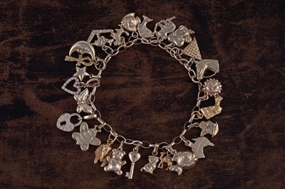 Lot 101 - A 9ct gold charm bracelet