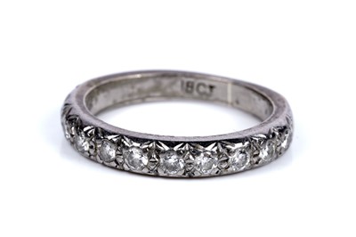 Lot 275 - A ten-stone diamond half-hoop eternity ring
