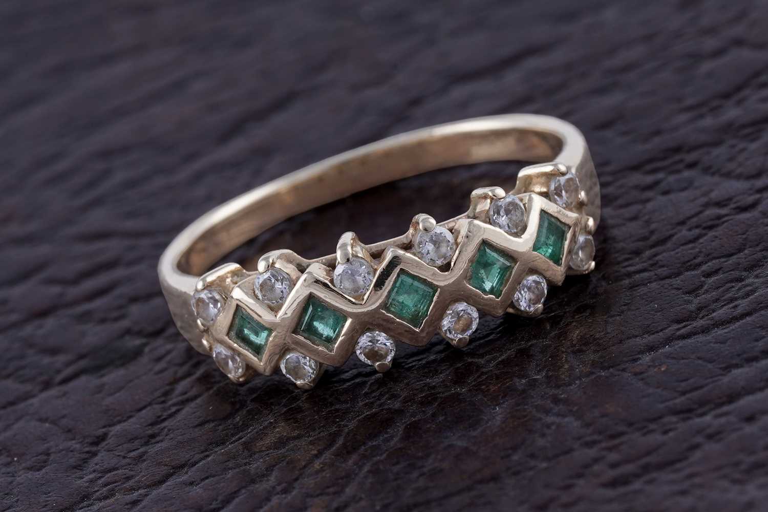 Lot 57 - A contemporary emerald and diamond ring