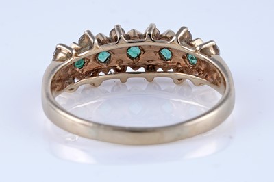 Lot 57 - A contemporary emerald and diamond ring