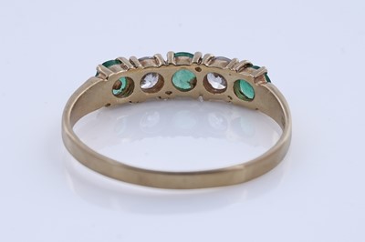 Lot 93 - An emerald ring on 18ct gold, and a pair of sapphire stud earrings