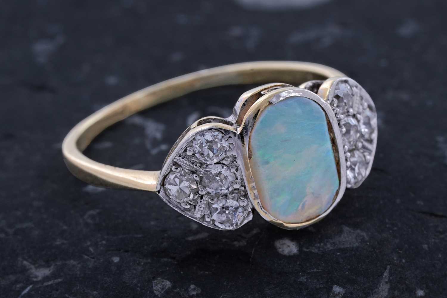 Lot 61 - An Edwardian Art Nouveau opal and diamond ring