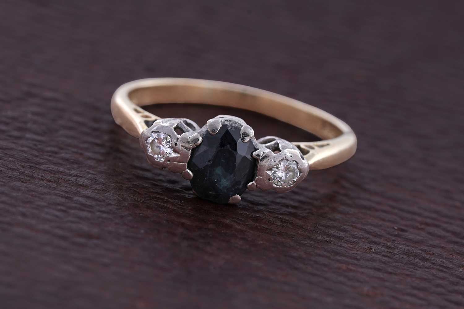 Lot 86 - A sapphire and diamond three-stone ring
