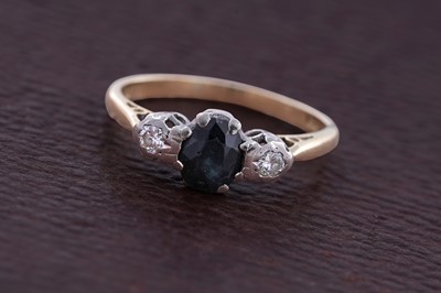 Lot 86 - A sapphire and diamond three-stone ring