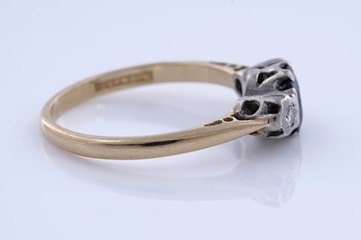 Lot 86 - A sapphire and diamond three-stone ring