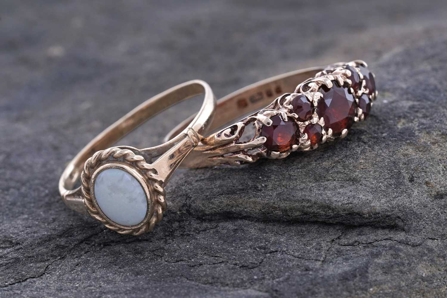 Lot 88 - An opal cabochon ring; and a garnet ring